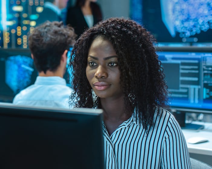 Woman sitting in front of computer screen