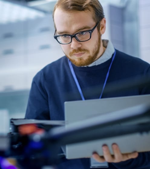 Man standing with laptop